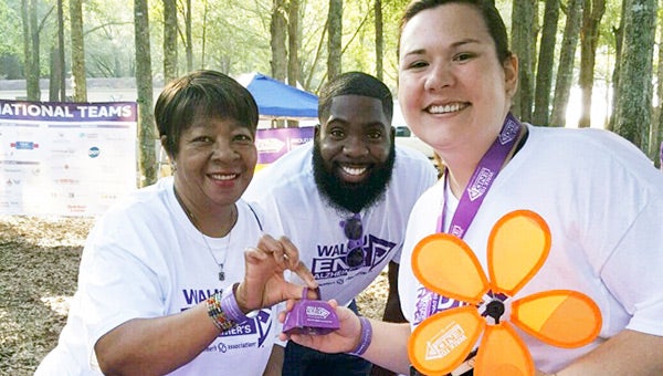 Emily Cain, Helen Bradley and Justin Flowers pose for a photo.  